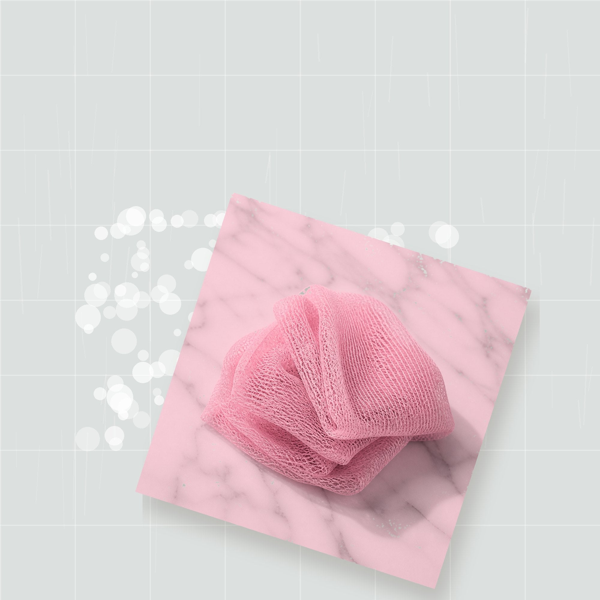 African net sponge with rich lather on clean shower tile